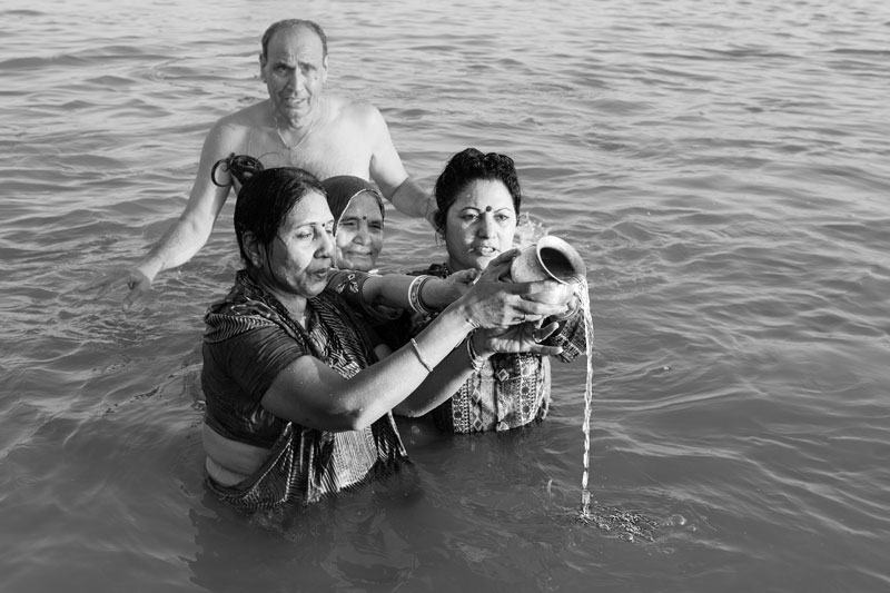 The connection between Water and Religion - devotees praying and offering sacred waters of Sangam (the confluence of rivers Ganga, Yamuna and Sarasvati) to deities at Prayag (Allahabad), Uttar Pradesh